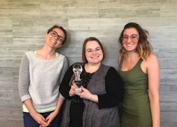 Three KRS designers holding a Retail Design Institute award