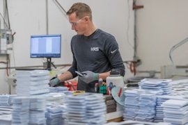 A KRS production team member sorting finished sign components
