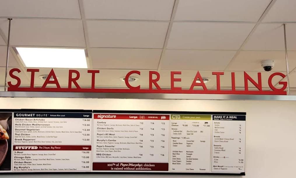 Papa Murphy’s restaurant interior featuring overhead “START CREATING” signage above the menu boards