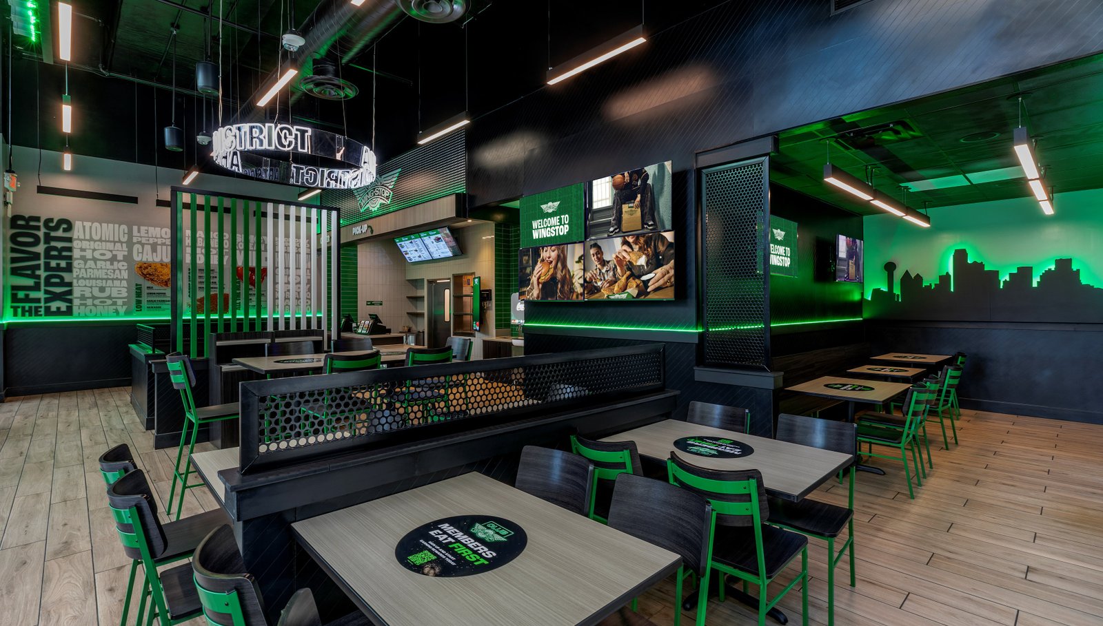 The Wingstop dining room localized with a Dallas skyline mural